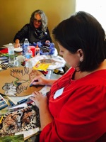 Ashley Hunt and Mary Jo Weatherly concentrate on their art work
